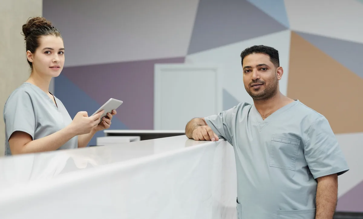 Recepção de clínica moderna com profissionais de saúde, ilustrando o ambiente hospitalar dos pilotos de IA